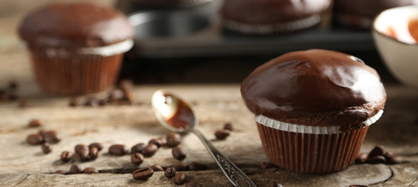 Tasty homemade chocolate muffins on wooden table